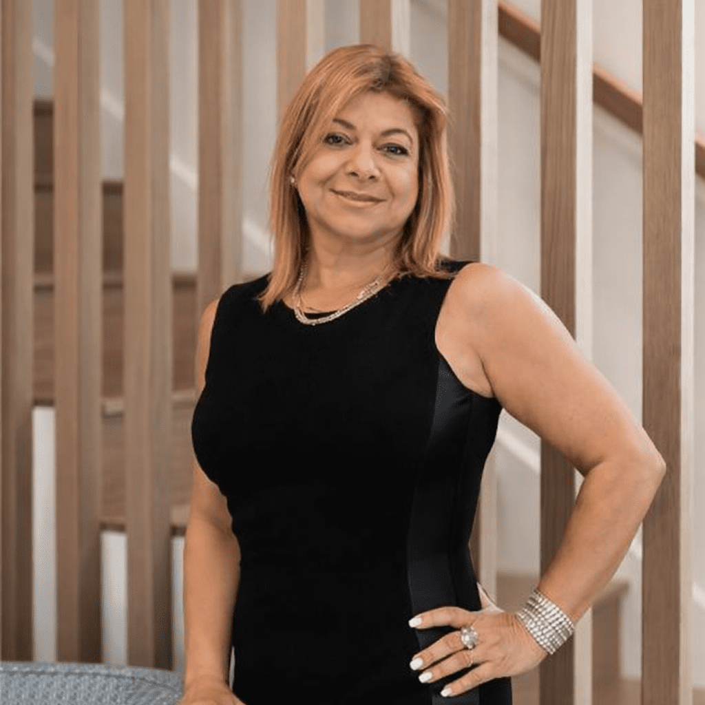 Woman in black dress smiling confidently