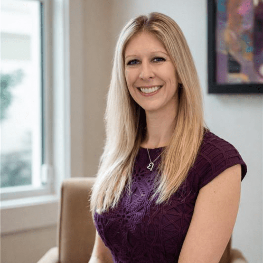 Blonde woman sitting in office setting